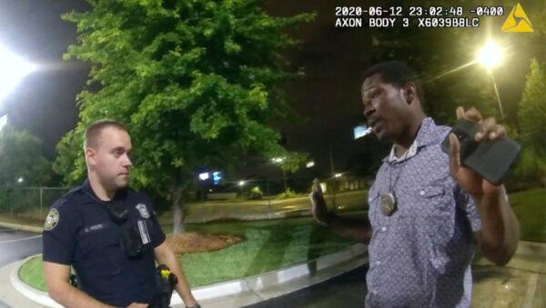 This screen grab taken from body camera video provided by the Atlanta Police Department shows Rayshard Brooks speaking with Officer Garrett Rolfe in the parking lot of a Wendy's restaurant, in Atlanta, Ga., late on June 12, 2020. (Atlanta Police Department via AP)