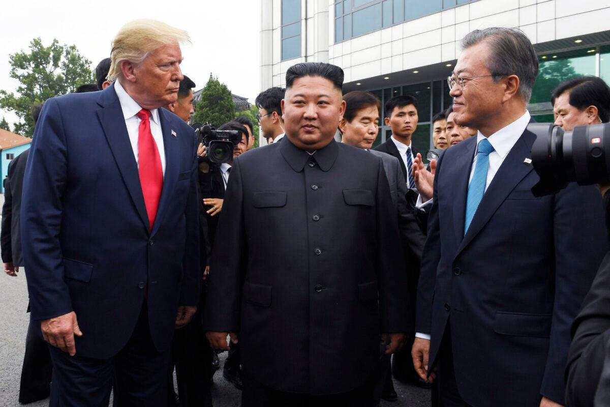 U.S. President Donald Trump meets with North Korean leader Kim Jong Un and South Korean President Moon Jae-in (right) at the border village of Panmunjom in the Demilitarized Zone, South Korea, on June 30, 2019. (Susan Walsh/AP)