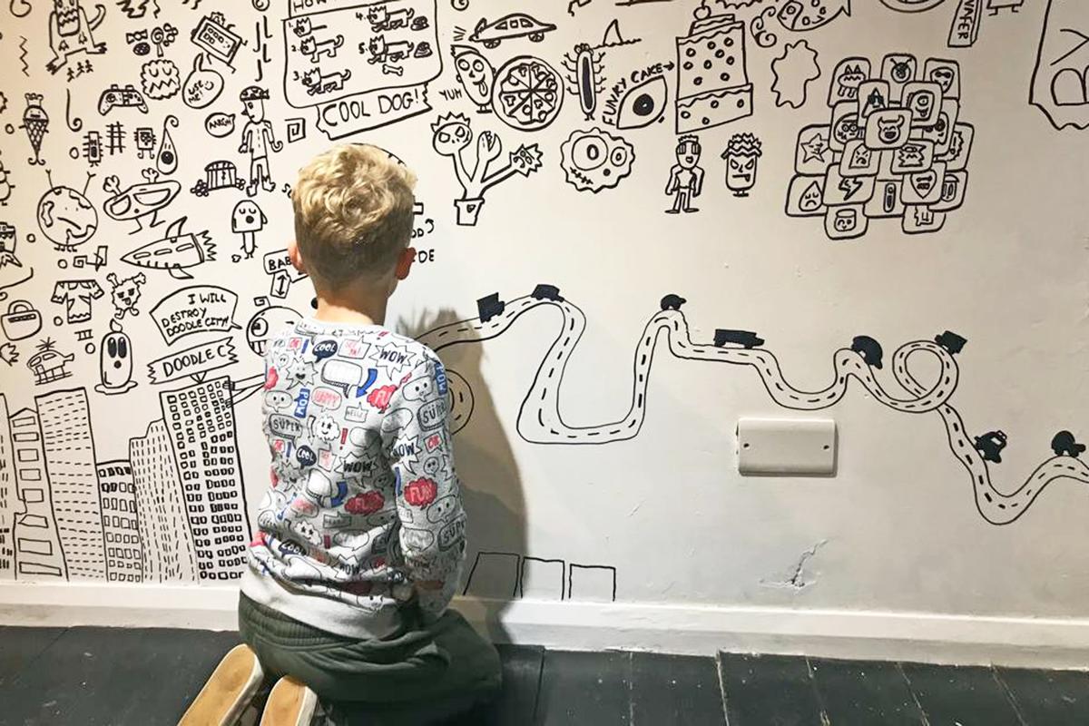 Joe Whale doodling on the wall at Number 4, a restaurant in Shrewsbury. (Caters News)