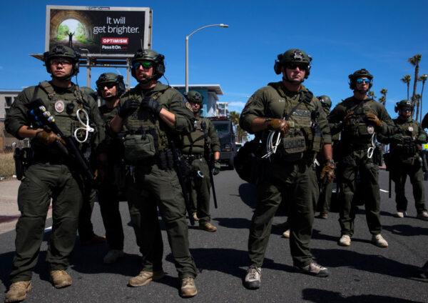 Huntington Beach SWAT team members stand ready for protesters, after violent demonstrations in response to George Floyd's death, in Huntington Beach, Calif., on May 31, 2020. (Brent Stirton/Getty Images)