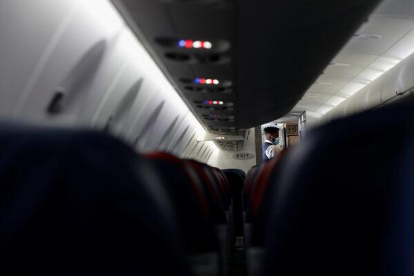 A flight attendant wears a protective face mask aboard a Delta flight to Hartsfield–Jackson Atlanta International Airport in Atlanta, Ga., on May 19, 2020. (Shannon Stapleton/Reuters)
