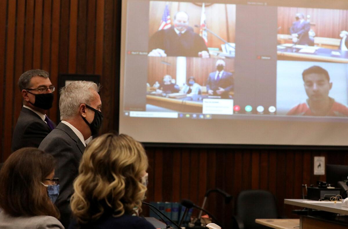 Santa Cruz County District Attorney Jeff Rosell speaks as proceedings get underway on Fri., June 12, 2020, during the arraignment of Steven Carrillo, seen in a video link at far right, for the killing of Santa Cruz Sheriff's Deputy Damon Gutzwiller in Santa Cruz, Calif. (Shmuel Thaler/Santa Cruz Sentinel/AP)