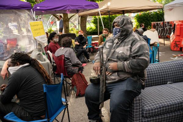 A man sits in an area inside the so-called autonomous zone in Seattle, Wash., on June 15, 2020. (David Ryder/Getty Images)