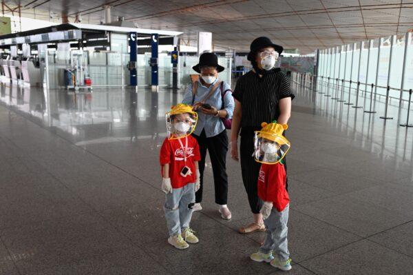 People wearing protective gear are pictured inside the terminal at Beijing's international airport, China, on June 17, 2020. (STR/AFP/Getty Images)