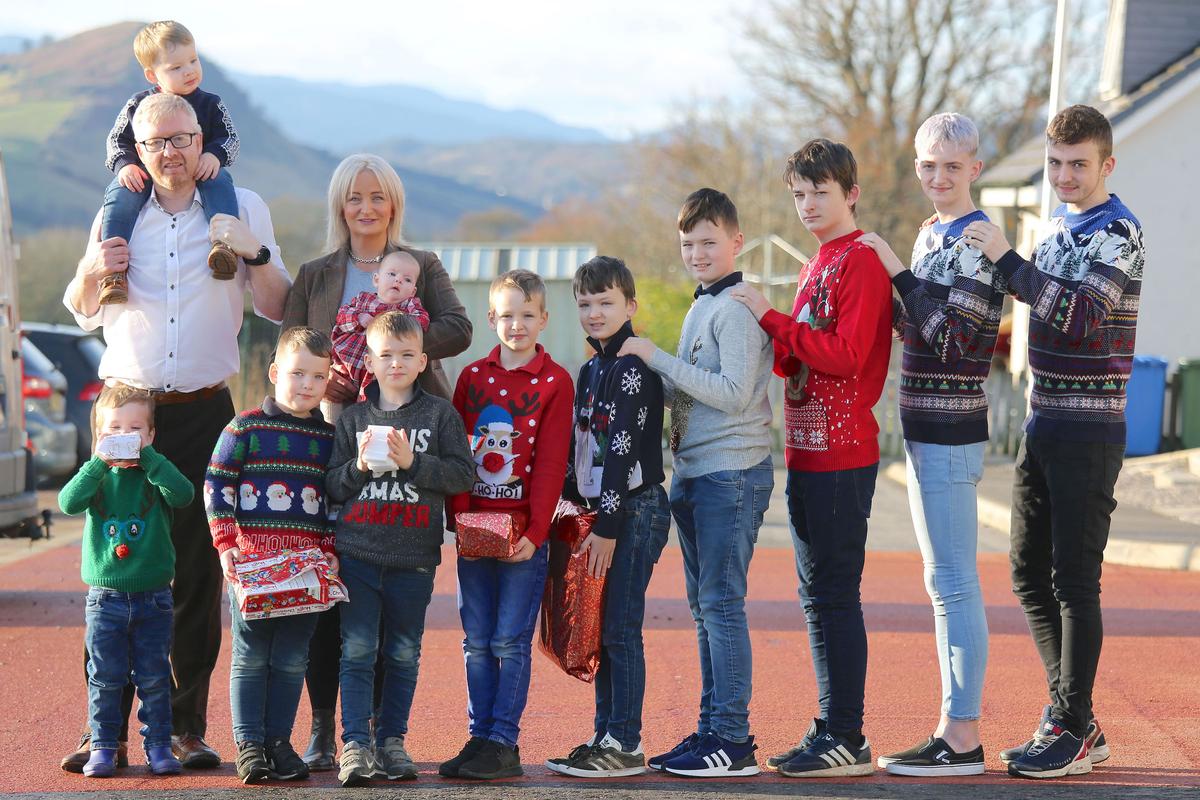 Alexis and David Brett with their 11 children including 10 boys and 1 girl. (Caters News)