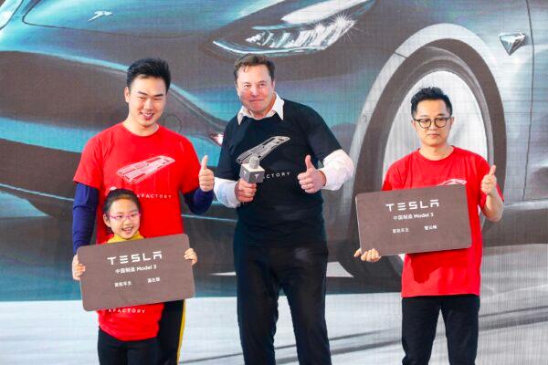 Tesla CEO Elon Musk (C) poses for photos with buyers during the Tesla China-made Model 3 Delivery Ceremony in Shanghai. (STR/AFP via Getty Images)