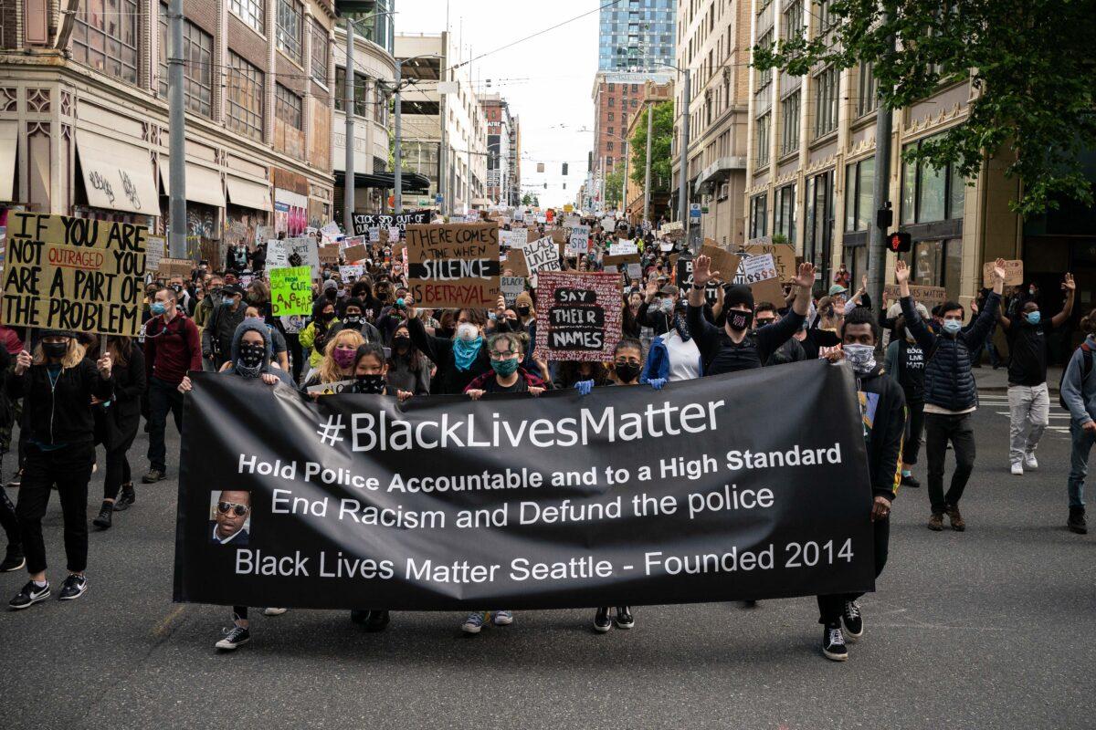  Black Lives Matter protesters march through a downtown street in Seattle, Wash., on June 14, 2020. (David Ryder/Getty Images)