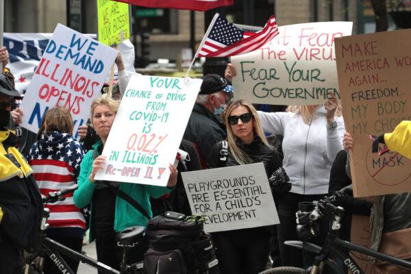 Demonstrators gather outside of the Thompson Center to protest restrictions instituted by Illinois Gov. J.B. Pritzker to curtail the spread of COVID-19, in Chicago, on May 1, 2020. (Scott Olson/Getty Images)