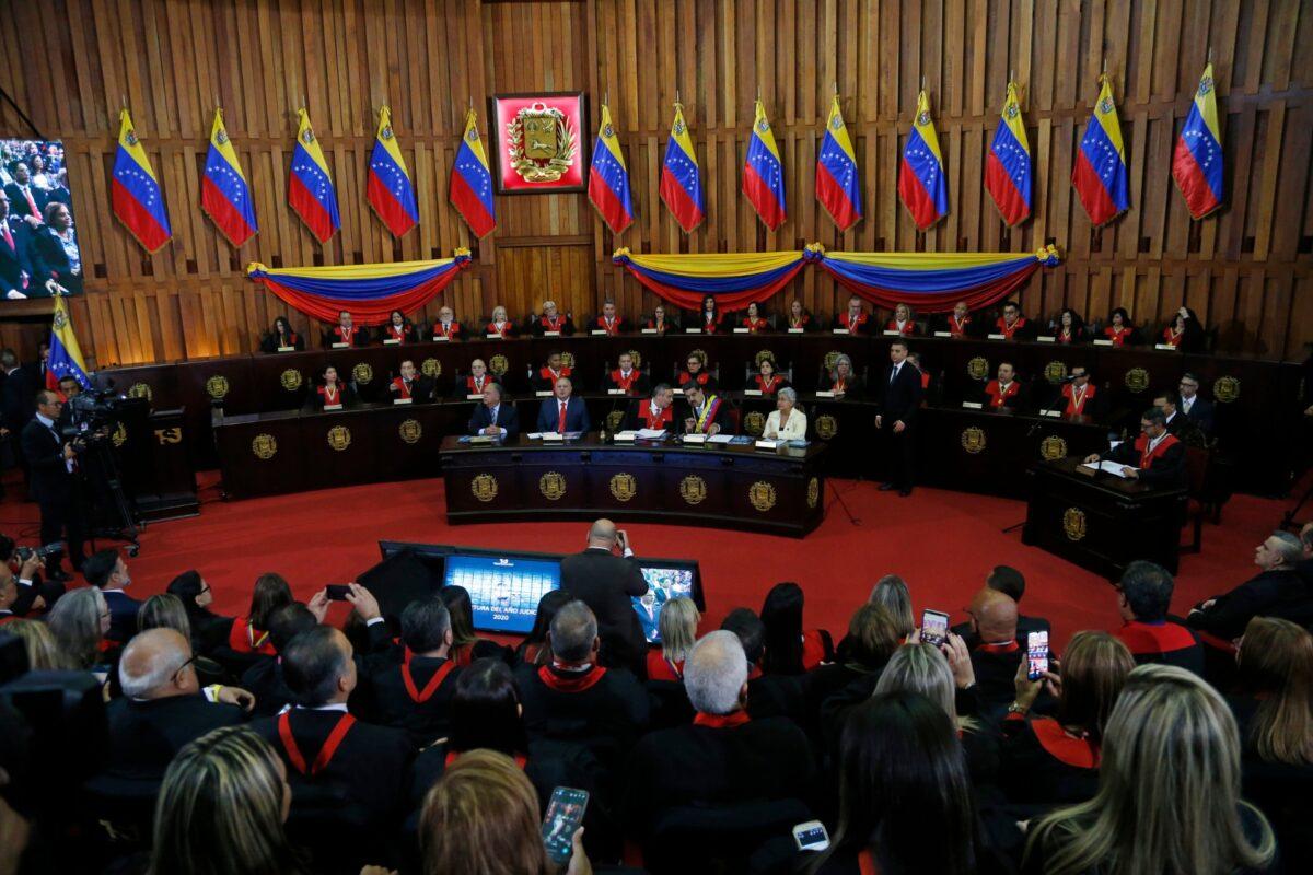 Venezuelan leader Nicolas Maduro, sitting at desk second from right, speaks with Supreme Court President Maikel Moreno at the Supreme Court before giving his annual presidential address in Caracas, Venezuela, on Jan. 31, 2020. (Ariana Cubillos/File/AP Photo)