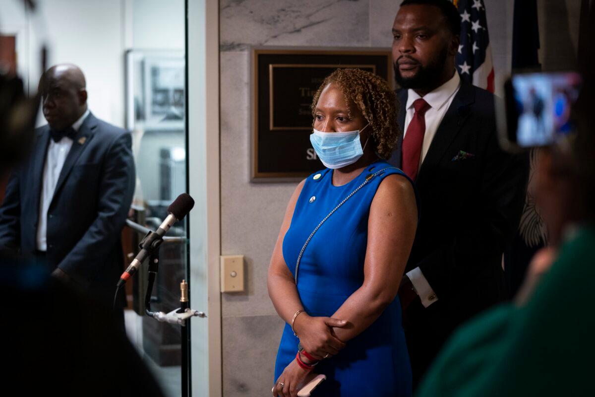 Alissa Charles-Findley, sister of the late Botham Jean, and civil rights attorney Lee Merritt, speak to reporters in the Hart Senate Office Building in Washington on June 16, 2020. (Drew Angerer/Getty Images)