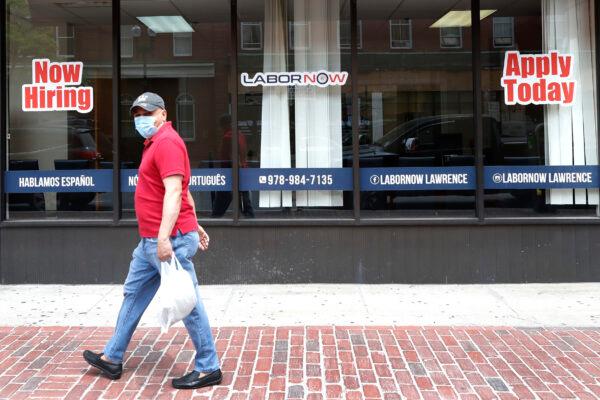 A man walks by a career center storefront in Lawrence, Mass., on June 5, 2020. (Elise Amendola/AP Photo)