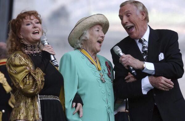 Dame Vera Lynn, centre, singer Petula Clark, left and entertainer Bruce Forsyth sing "We'll Meet Again", during the World War II 60th Anniversary Service at Horse Guards Parade, in London on July, 10, 2005. (Edmond Terakopian/PA via AP)