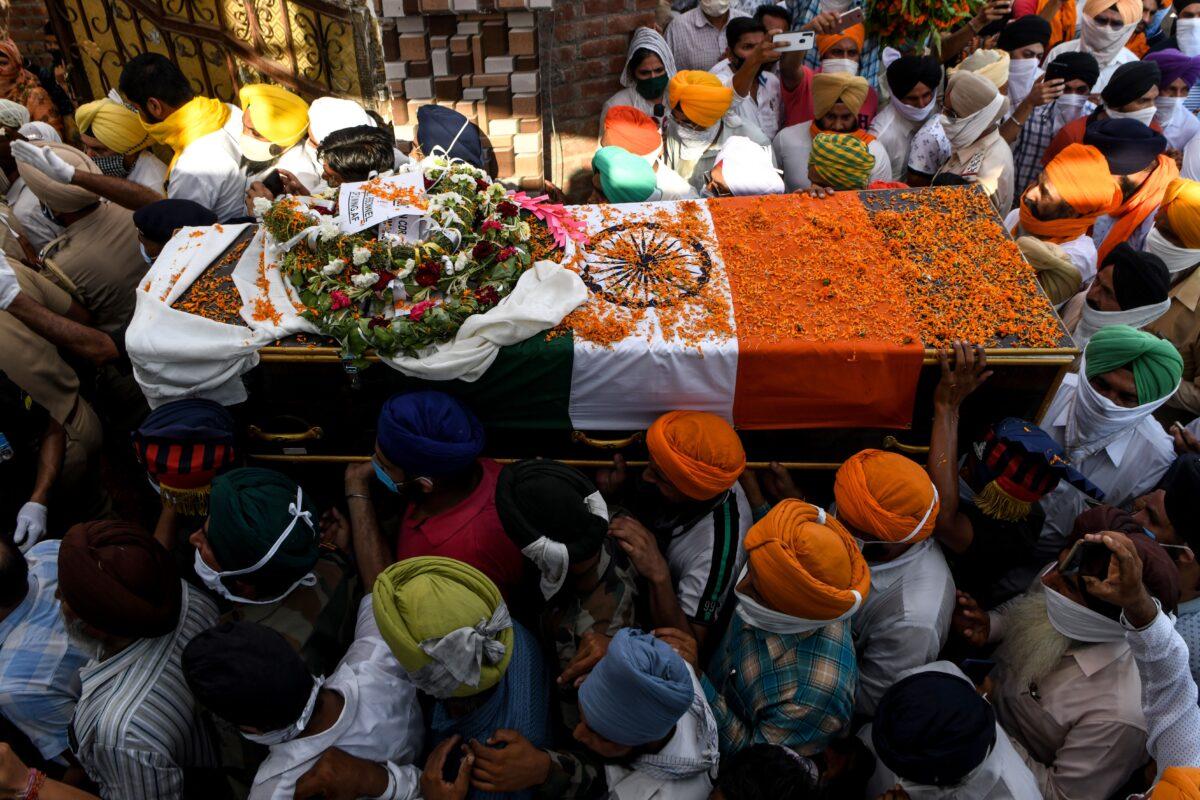 Family members and villagers carry the coffin of soldier Satnam Singh who was killed in a recent clash with Chinese forces in the Galwan valley area, during the cremation ceremony at Bhojraj village near Gurdaspur on June 18, 2020. (Narinder Nanu / AFP via Getty Images)