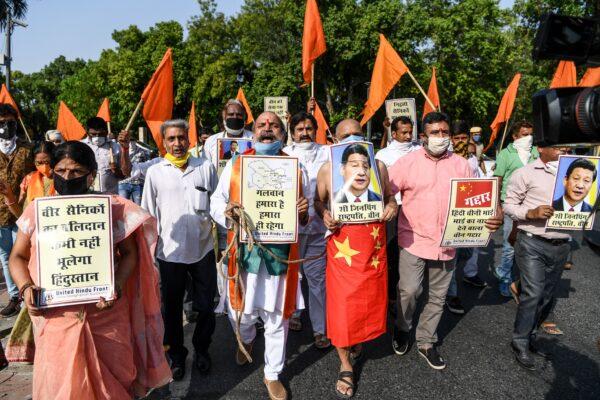 Protesters shout slogans as they hold posters of Chinese President Xi Jinping during an anti-China demonstration near the Chinese embassy in New Delhi, India, on June 18, 2020. (Sajjad Hussain/AFP/Getty Images)