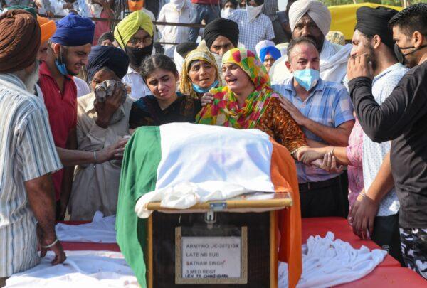 Wife Jaswinder Kaur (4R), her daughter Sandeep Kaur (4L), her son Prabhjot Singh (2R), father Jagir Singh (3L), mother Kashmir Kaur (C) of soldier Satnam Singh who was was killed in a recent clash with Chinese forces in the Galwan valley area, during the cremation ceremony at Bhojraj village near Gurdaspur on June 18, 2020. (Narinder Nanu/AFP/Getty Images)