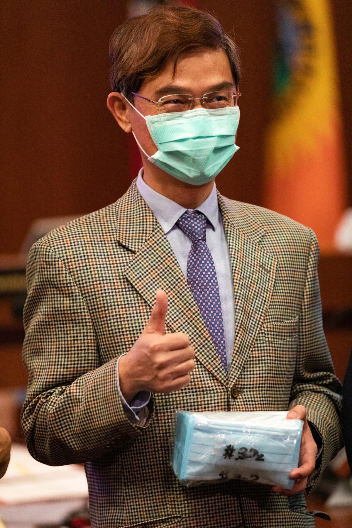 Ambassador Abraham Wen-Shang Chu gives a thumbs up to one package of the 20,000 surgical masks donated by Taiwan to help Orange County combat the COVID-19 pandemic in Santa Ana, Calif., on June 16, 2020. (John Fredricks/The Epoch Times)