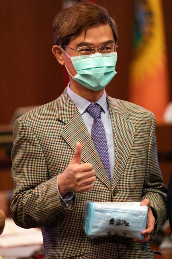 Ambassador Abraham Wen-Shang Chu gives thumbs up to one package of the 20,000 surgical masks donated by Taiwan to help Orange County combat the COVID-19 pandemic in Santa Ana, Calif., on June 16, 2020. (John Fredricks/The Epoch Times)