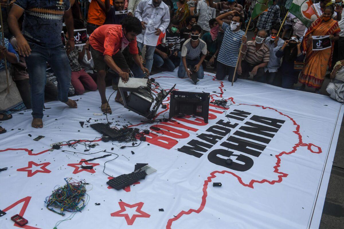 Indian Congress Party supporters leave Chinese goods on a flag displaying the country of China, along with an inscription reading "Boycott Made in China," during an anti-China demonstration in Kolkata, India, on June 18, 2020. (Dibyangshu Sarkar/AFP via Getty Images)