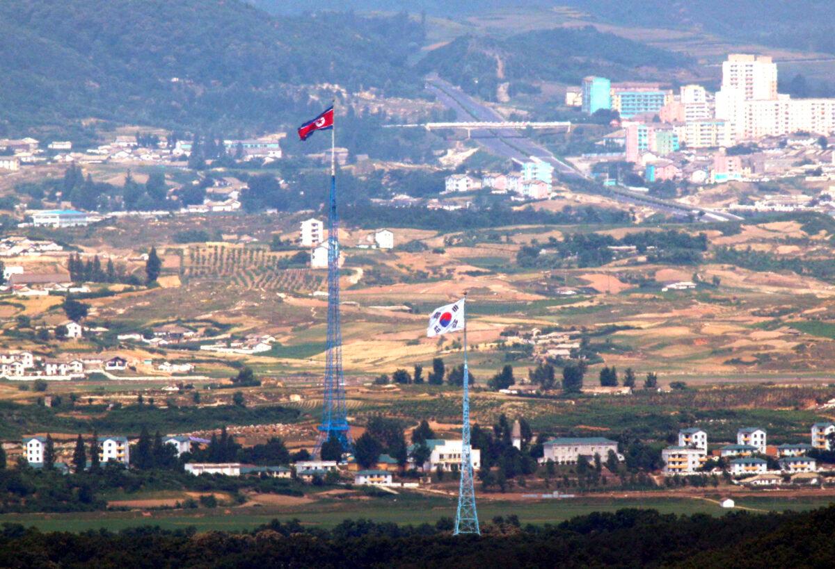 Flags of North Korea, rear, and South Korea, front, flutter in the wind in this photo taken from Paju, South Korea, on June 19, 2020. (Seoul Myung-gon/Yonhap via AP)