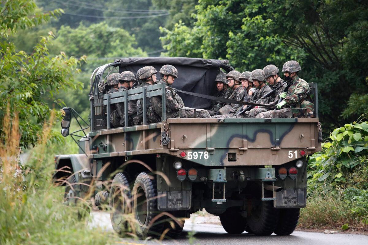 South Korean army soldiers ride on the back of a truck in Paju, South Korea, near the border with North Korea, on June 19, 2020. (Ahn Young-joon/AP Photo)
