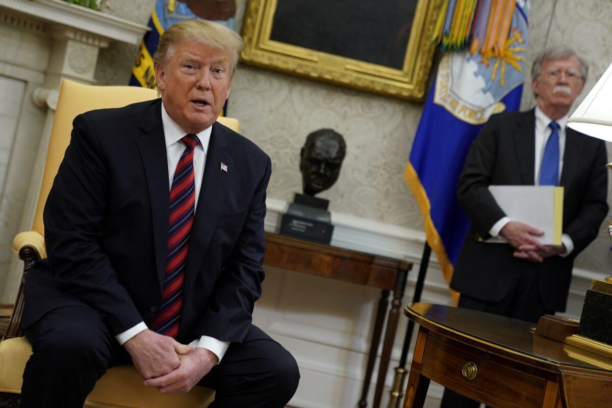 President Donald Trump talks to reporters as then-National Security Advisor John Bolton looks on during a meeting with Slovakia's Prime Minister Peter Pellegrini in the Oval Office at the White House in Washington, May 3, 2019. (Jonathan Ernst/Reuters)