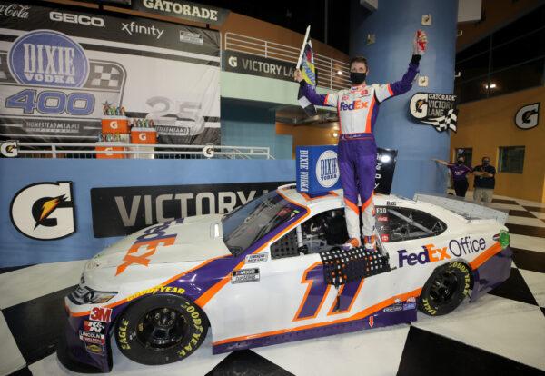 Denny Hamlin, driver of the #11 Toyota, celebrates in Victory Lane after winning the NASCAR Cup Series Dixie Vodka 400 at Homestead-Miami Speedway in Homestead, Fla., on June 14, 2020. (Chris Graythen/Getty Images)