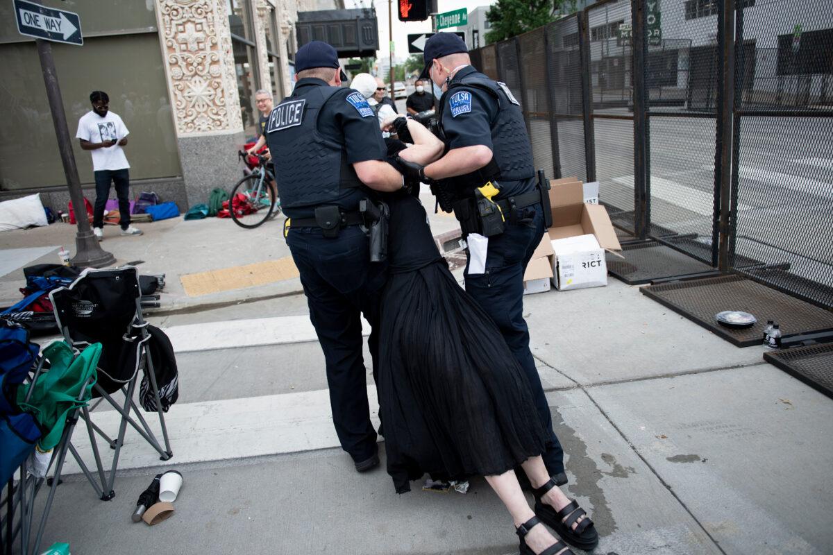 Tulsa Police take protester Sheila Buck into custody near an entrance to a security checkpoint for a rally with President Donald Trump at the BOK Center in Tulsa, Oklahoma, on June 20, 2020. (Brendan Smialowski/AFP/Getty Images)