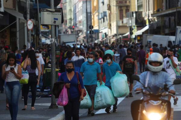People walk with bags at a popular shopping street amid the CCP virus outbreak, in Sao Paulo, Brazil, on June 19, 2020. (Amanda Perobelli/Reuters)