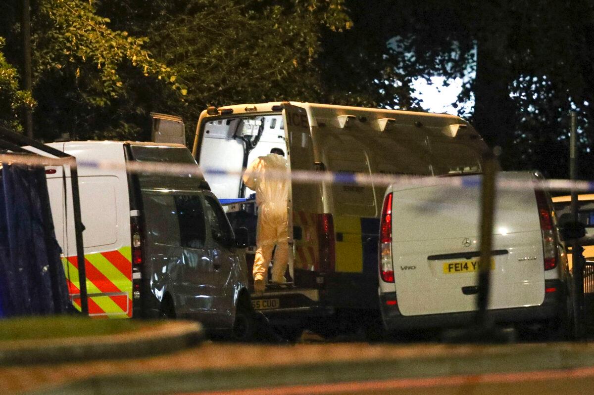 Forensic officers work at Forbury Gardens park where an evening stabbing attack took place the previous day, in Reading, England, early June 21, 2020. (Steve Parsons/PA via AP)
