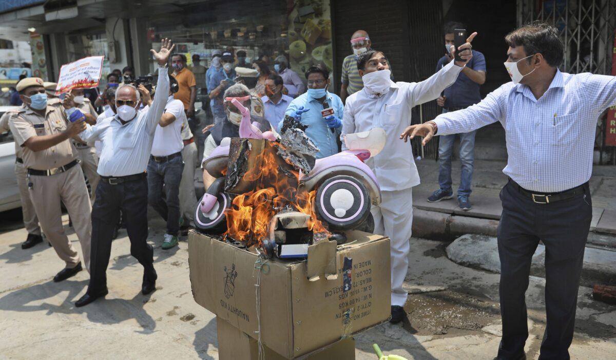 Indian traders burn Chinese products during a protest against Chinese aggression in Indian territory, in New Delhi, India, on June 22, 2020. (Manish Swarup/AP Photo)