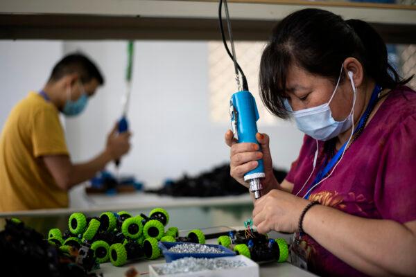 Workers assembling toys at the Mendiss toy factory in Shantou, Guangdong Province, on May 20, 2020. (Noel Celis/AFP via Getty Images)