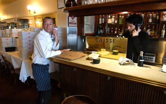 Head chef Geraud Fabre (L) of French restaurant France-Soir waits for take-away orders in Melbourne, Australia on May 8, 2020 (Willian West/ Getty Images)