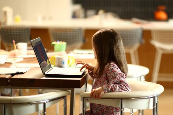 A kindergarten student does schoolwork at her home in a file photo in San Anselmo, Calif., on March 18, 2020. (Ezra Shaw/Getty Images)
