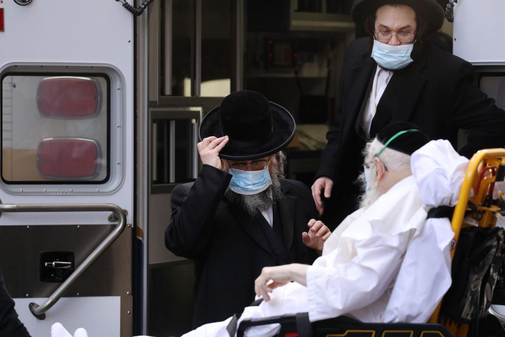 Hasidic men speak with an elderly patient being brought into Mount Sinai Hospital amid the COVID-19 pandemic in New York City on April 1, 2020. (Spencer Platt/Getty Images)