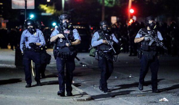 Police take back the streets at around midnight after firing copious amounts of tear gas to disperse protesters and rioters outside the Minneapolis Police 5th Precinct during the fourth night of protests and violence following the death of George Floyd, in Minneapolis, on May 29, 2020. (Charlotte Cuthbertson/The Epoch Times)