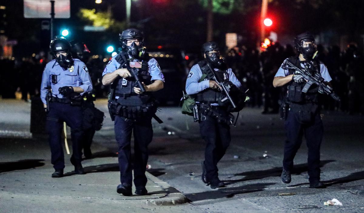 Police take back the streets at around midnight after firing copious amounts of tear gas to disperse protesters and rioters outside the Minneapolis Police 5th Precinct during the fourth night of protests and violence following the death of George Floyd, in Minneapolis, Minn., on May 29, 2020. (Charlotte Cuthbertson/The Epoch Times)