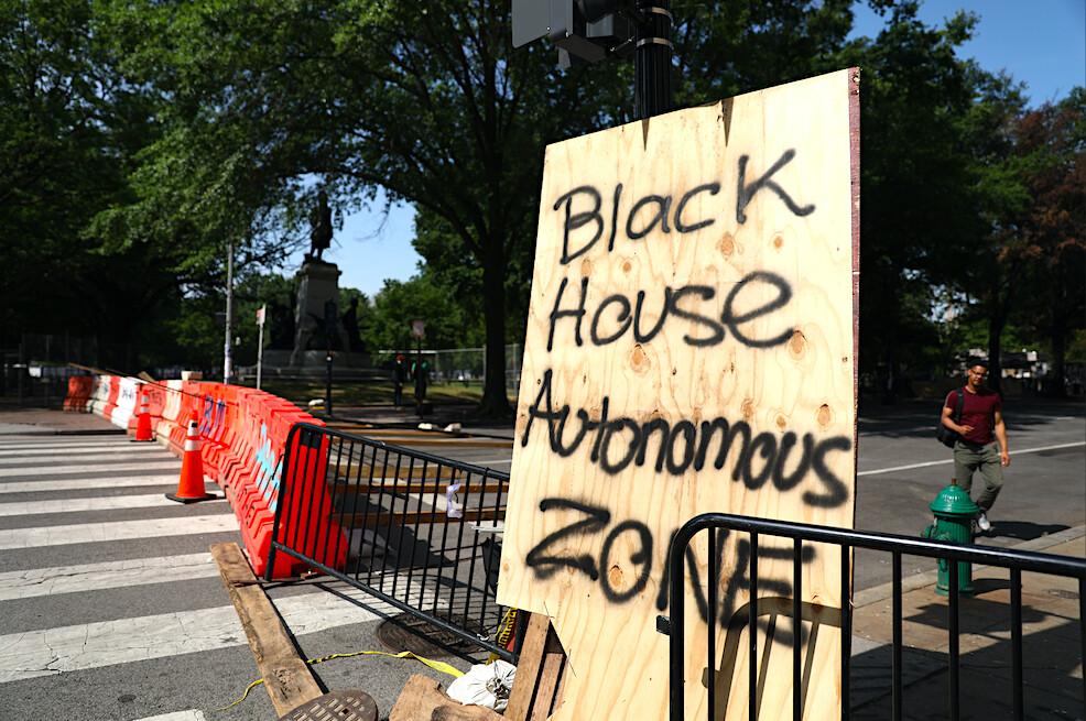 Barriers and a sign block H Street just before police clear the area after protesters set up an autonomous zone the previous night, just north of the White House in Washington on June 23, 2020. (Charlotte Cuthbertson/The Epoch Times)
