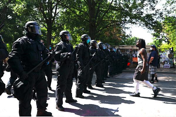 Police clear H Street and Black Lives Matter Plaza after protesters set up an autonomous zone the previous night, just north of the White House in Washington, on June 23, 2020. (Charlotte Cuthbertson/The Epoch Times)