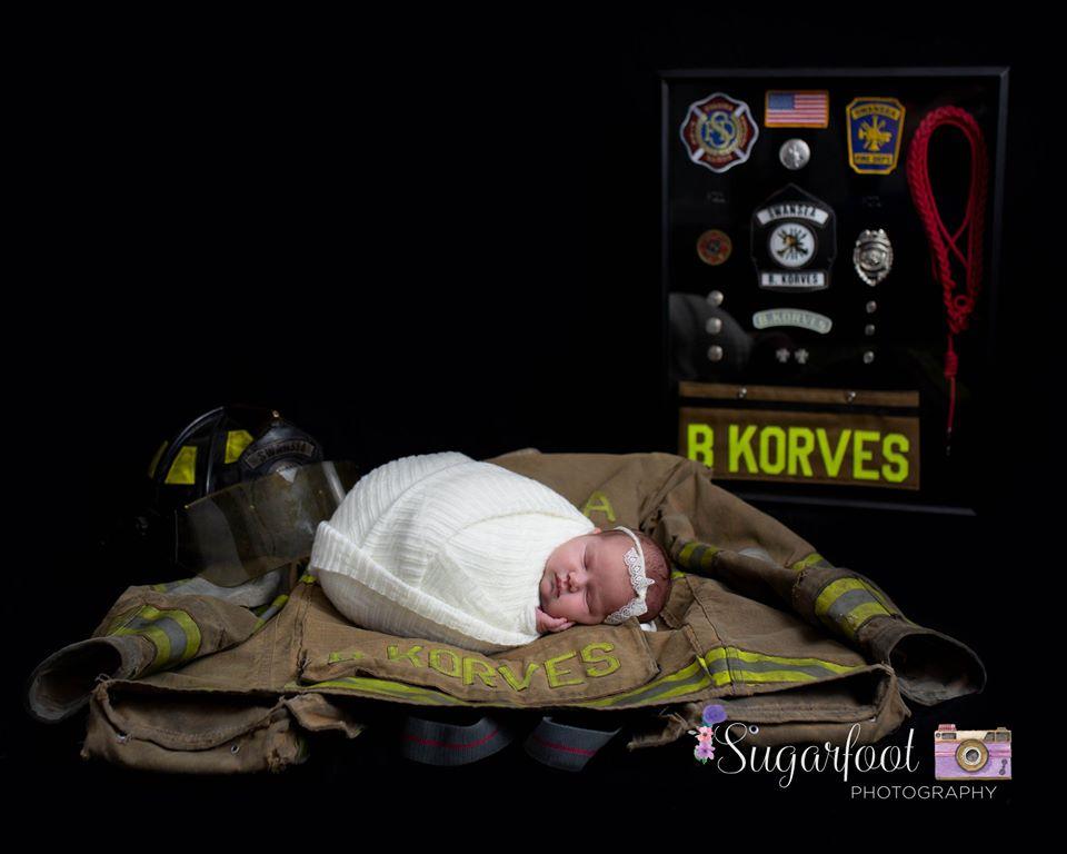 Baby Brett Grace Korves with her father's gear. (Courtesy of <a href="https://www.sugarfootphotography.com/">Sugarfoot Photography</a>)