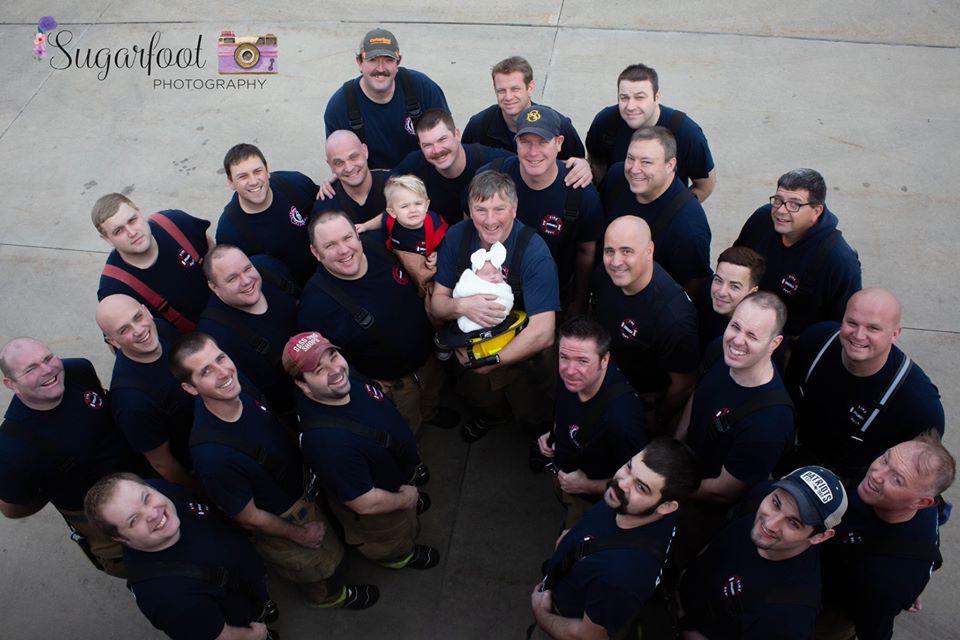 Brett Grace Korves with her grandfather and the entire fire department crew. (Courtesy of <a href="https://www.sugarfootphotography.com/">Sugarfoot Photography</a>)