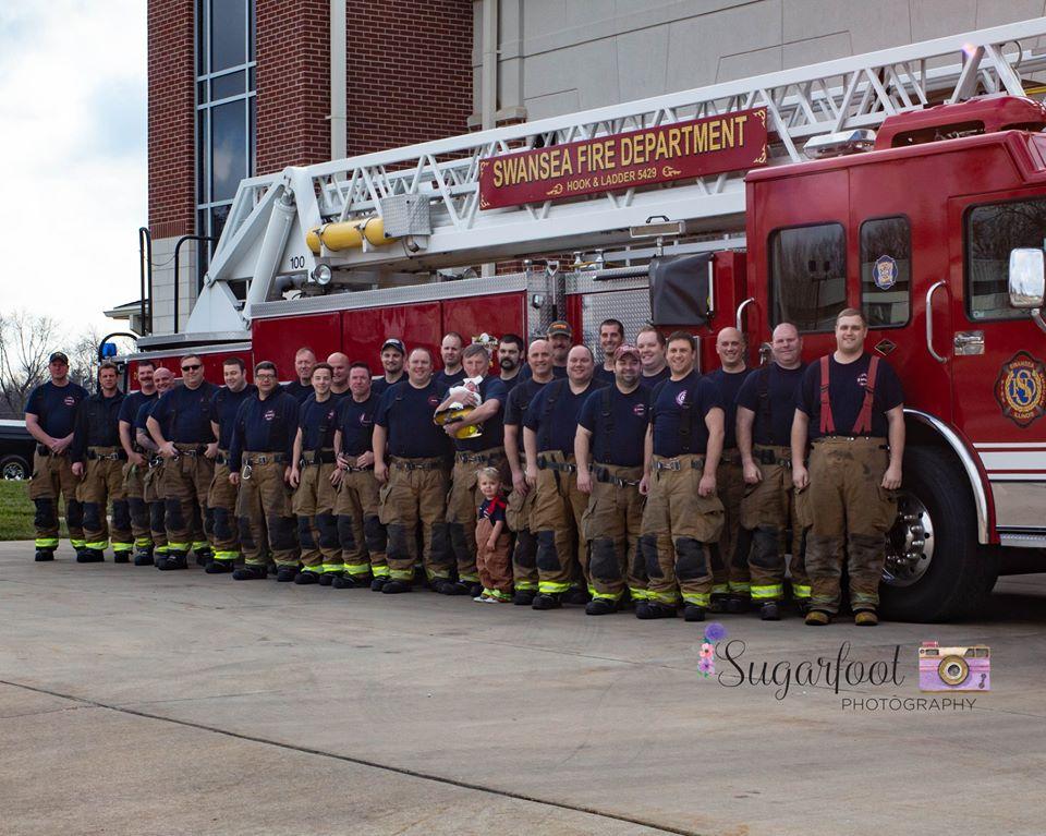 The newborn with the Swansea Fire Department. (Courtesy of <a href="https://www.sugarfootphotography.com/">Sugarfoot Photography</a>)