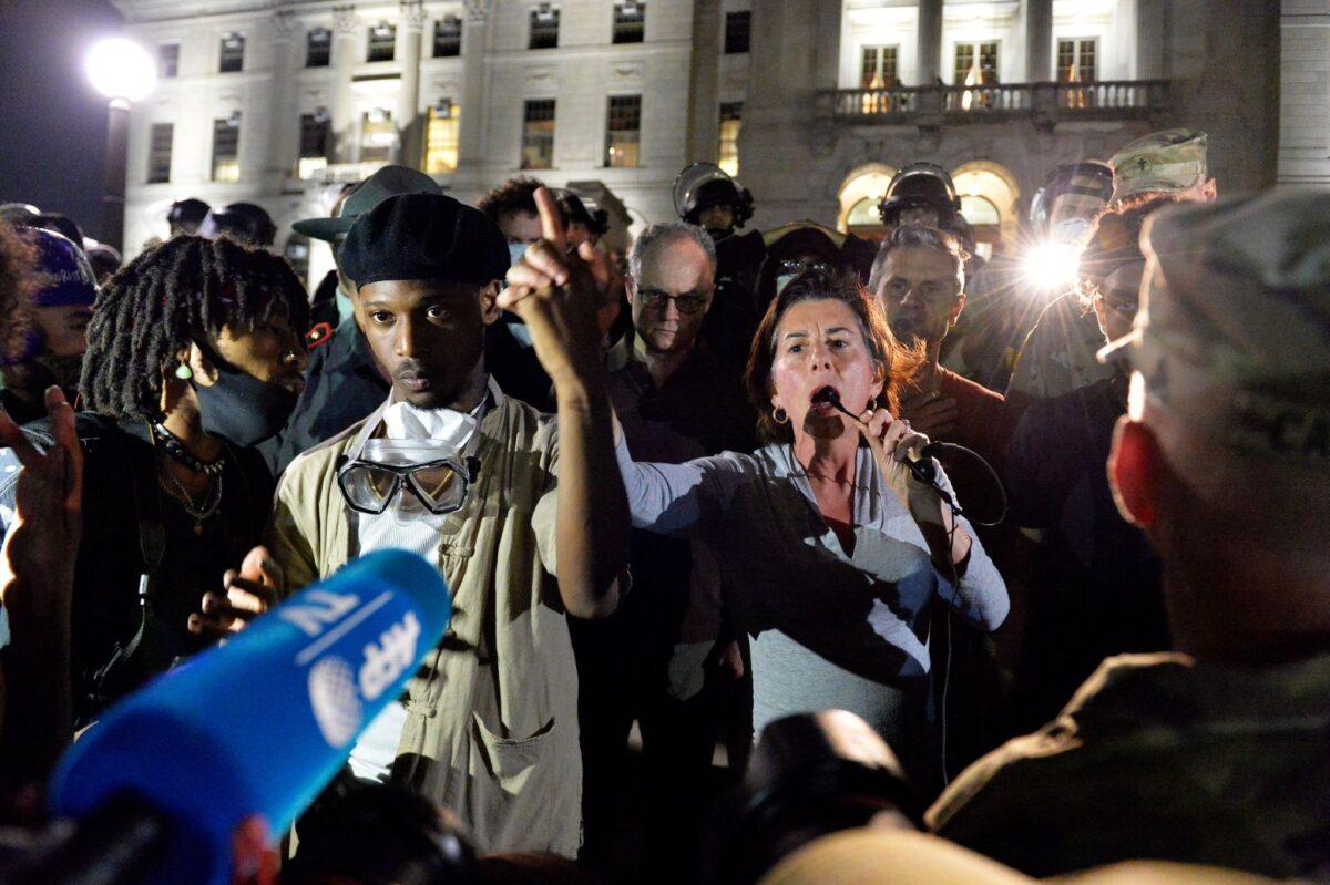 Governor Gina Raimondo (C) addresses protesters, saying a prayer with them and telling them she will listen and work with them, after they called for her to come out and hear their demands during a Black Lives Matter rally on the steps of the State House in Providence, Rhode Island on June 5, 2020. (Joseph Prezioso / AFP) (Joseph Prezioso/AFP via Getty Images)