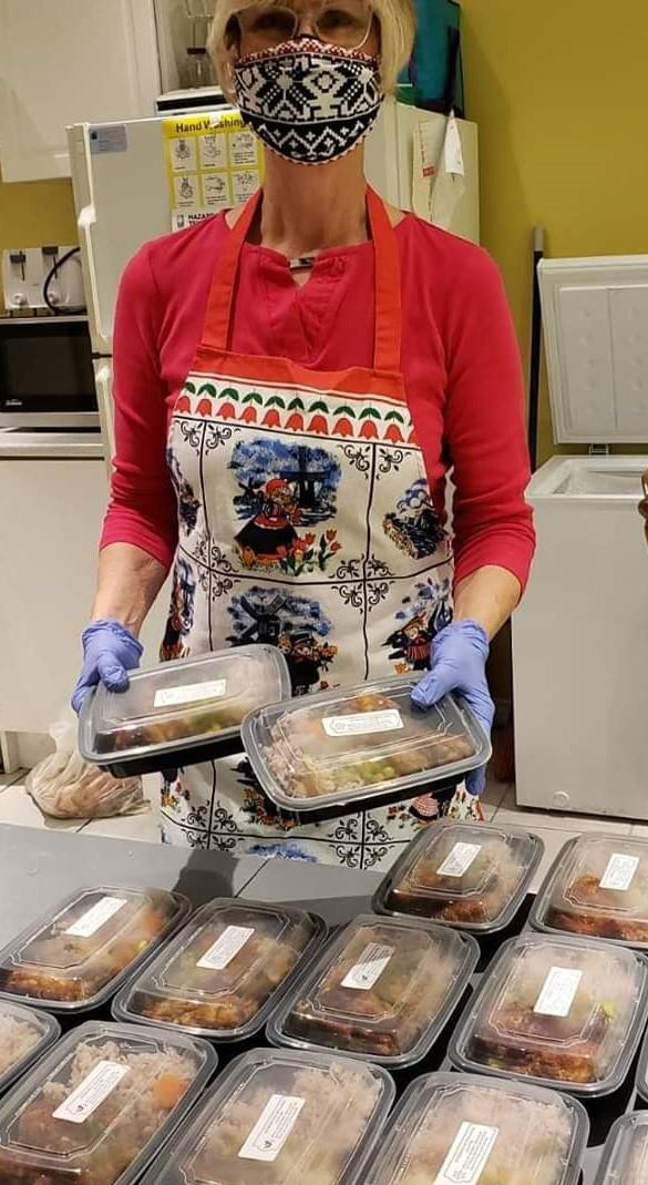 A staff member with meals for seniors at the Homebound Wellness Centre in Ajax, Ontario. (Courtesy Homebound Wellness Centre)