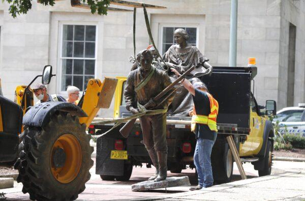 Crews add the Henry Wyatt Monument to a truck after removing them from the North Carolina state capitol in Raleigh on June 20, 2020. (Ethan Hyman/The News & Observer via AP)