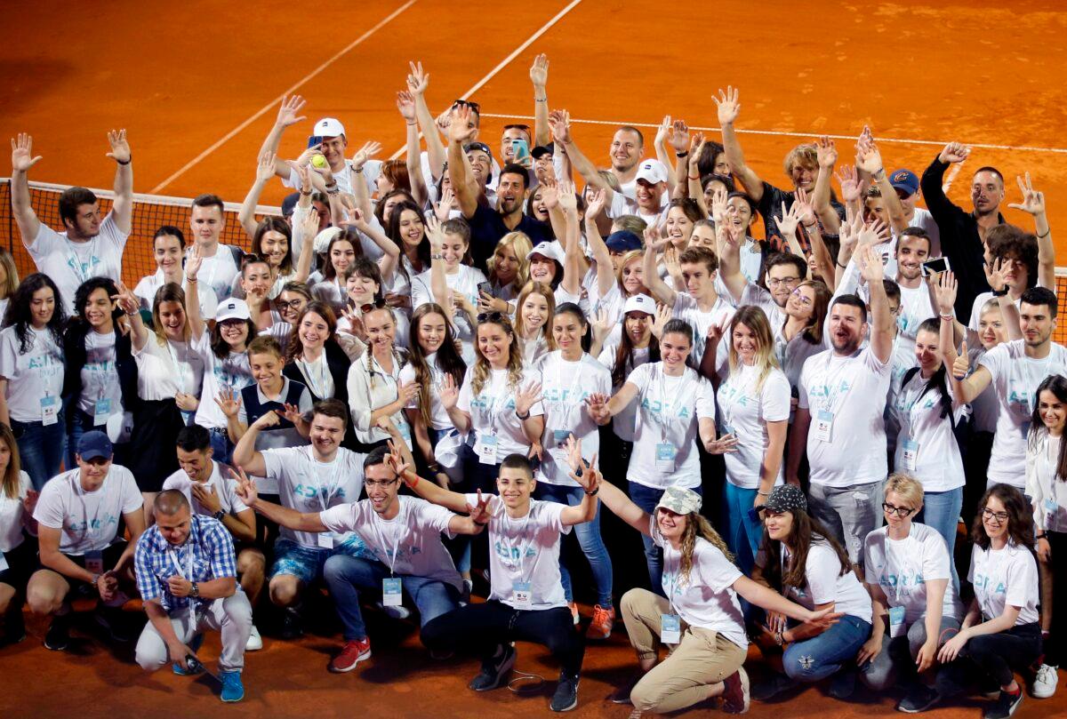 Serbia's Novak Djokovic (C) poses with volunteers and players after the Adria Tour charity tournament in Belgrade, Serbia, on June 14, 2020. (Darko Vojinovic/AP Photo)