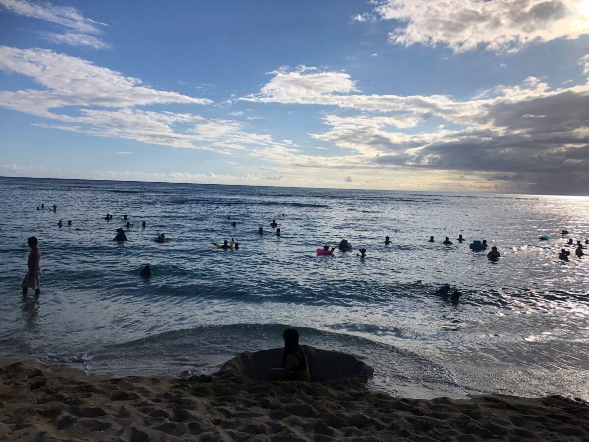 People enjoy the water at a beach in Waikiki, Honolulu, Hawaii on May 13, 2020. (Jennifer Sinco Kelleher/AP Photo)