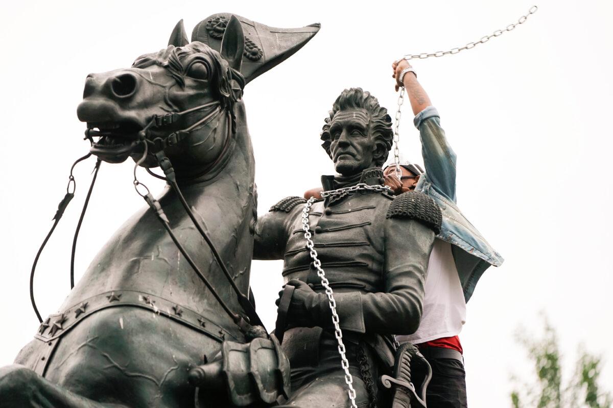 A vandal wraps chains around the neck of the statue of former President Andrew Jackson during an attempt to pull the statue down in the middle of Lafayette Park in front of the White House during protests in Washington, D.C., on June 22, 2020. (Joshua Roberts/Reuters)