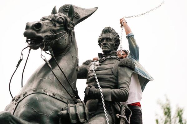 A rioter wraps chains around the neck of the statue of U.S. President Andrew Jackson during an attempt by vandals to pull the statue down in the middle of Lafayette Park in front of the White House during protests in Washington, on June 22, 2020. (Joshua Roberts/Reuters)