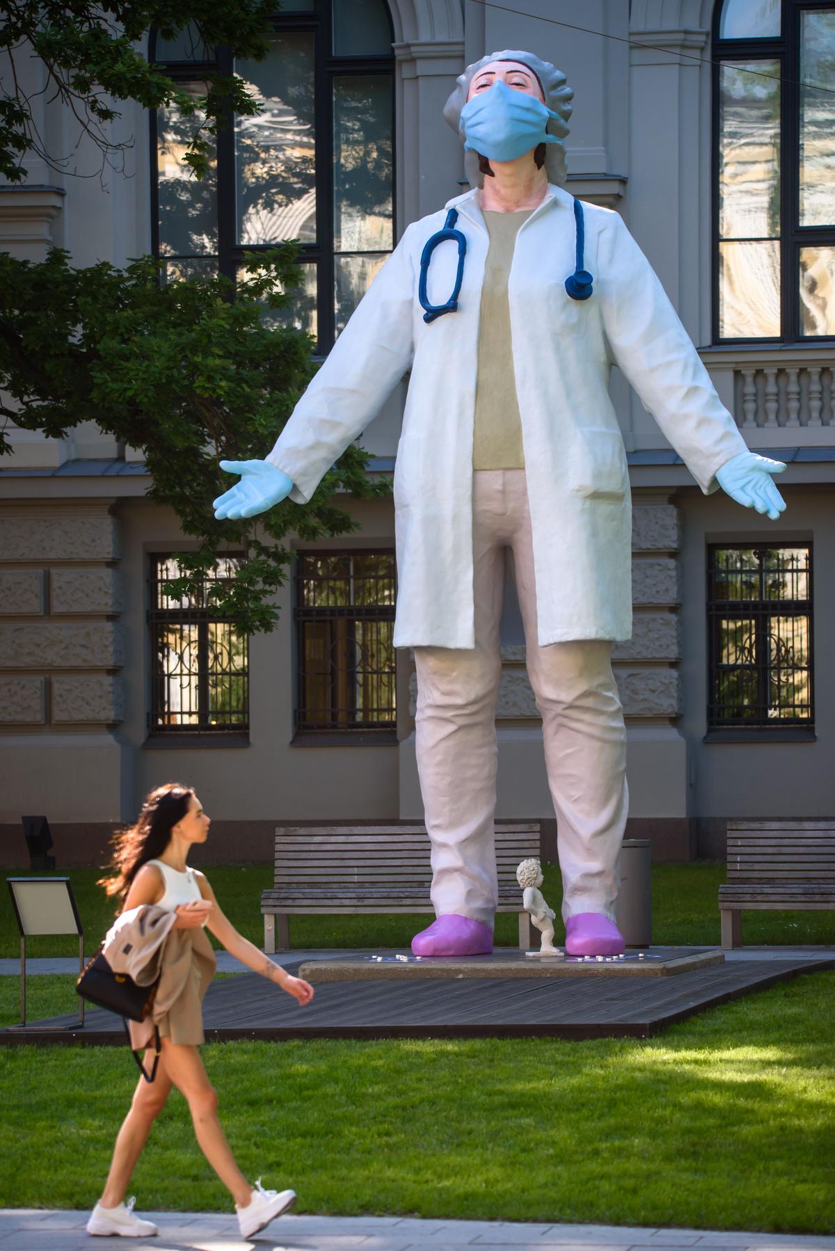 A 6-meter-high statue of a female doctor by Latvian artist Aigars Bikše called "Medics to the World," which stands in front of the National Museum of Arts as a sign of gratitude from the Latvian society to all health care workers for their selfless service during the CCP virus pandemic, on June 17, 2020, in Riga, Latvia. (GINTS IVUSKANS/AFP via Getty Images)