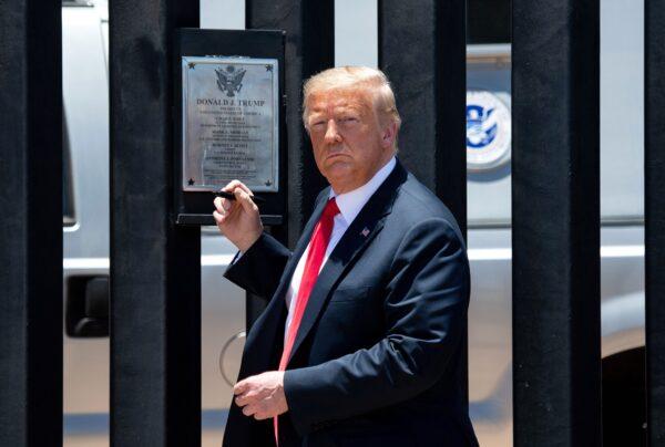 President Donald Trump looks on before signing a plaque as he participates in a ceremony commemorating the 200th mile of border wall at the international border with Mexico in San Luis, Ariz., on June 23, 2020. (Saul Loeb/AFP via Getty Images)